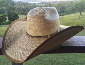 The Backhouse Reiner hat on a balcony